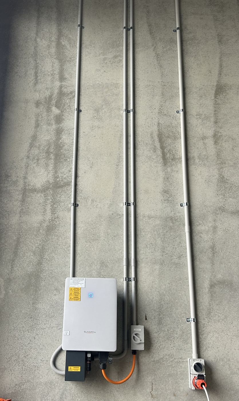 Sungrow inverter and neat conduit runs on a commercial job