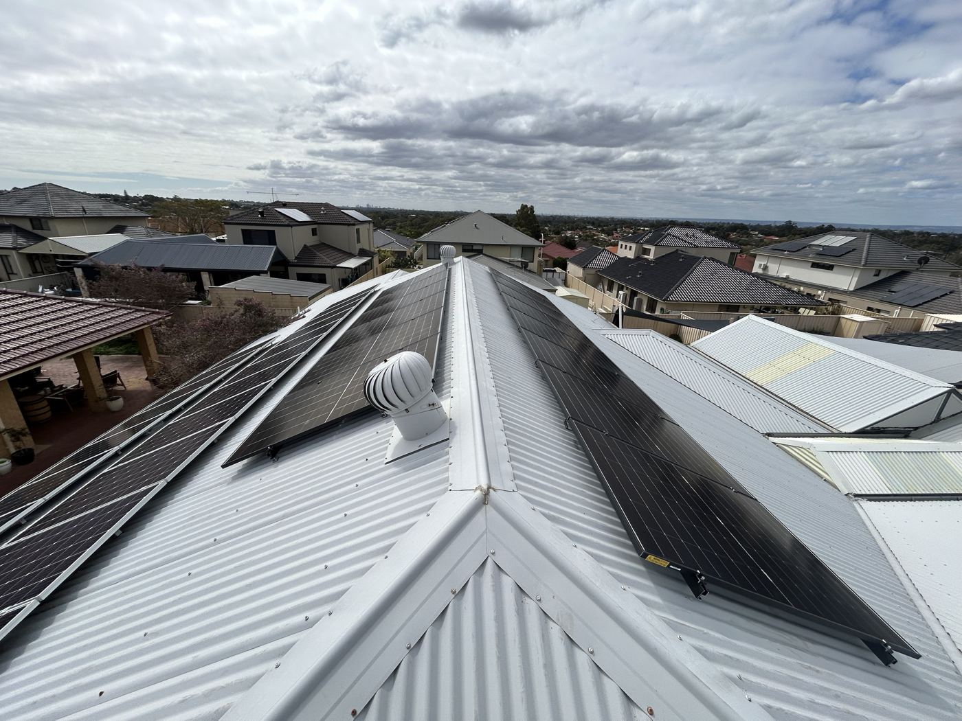 Solar array across both sides of a metal roof