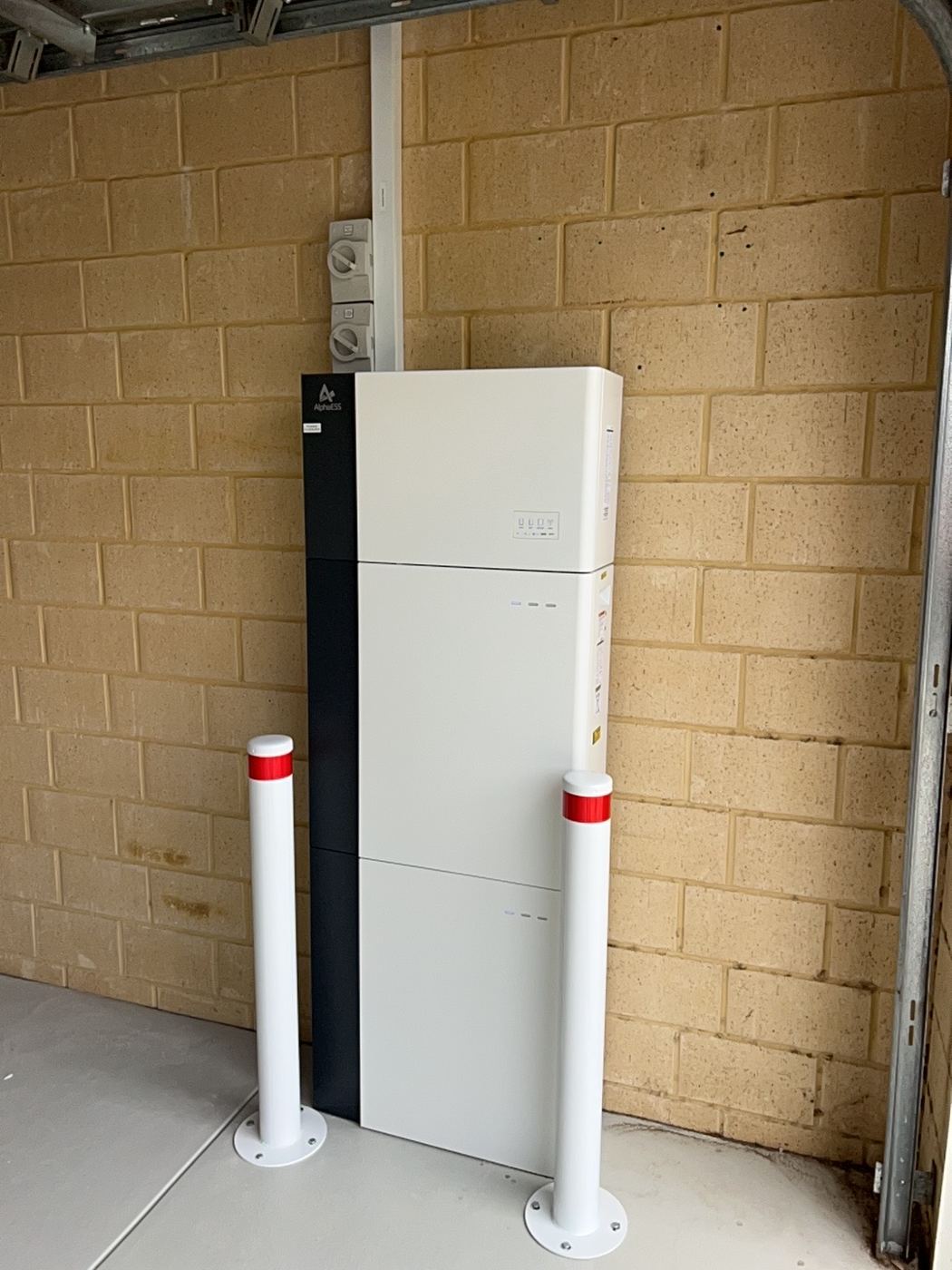 Alpha ESS battery protected by two bollards