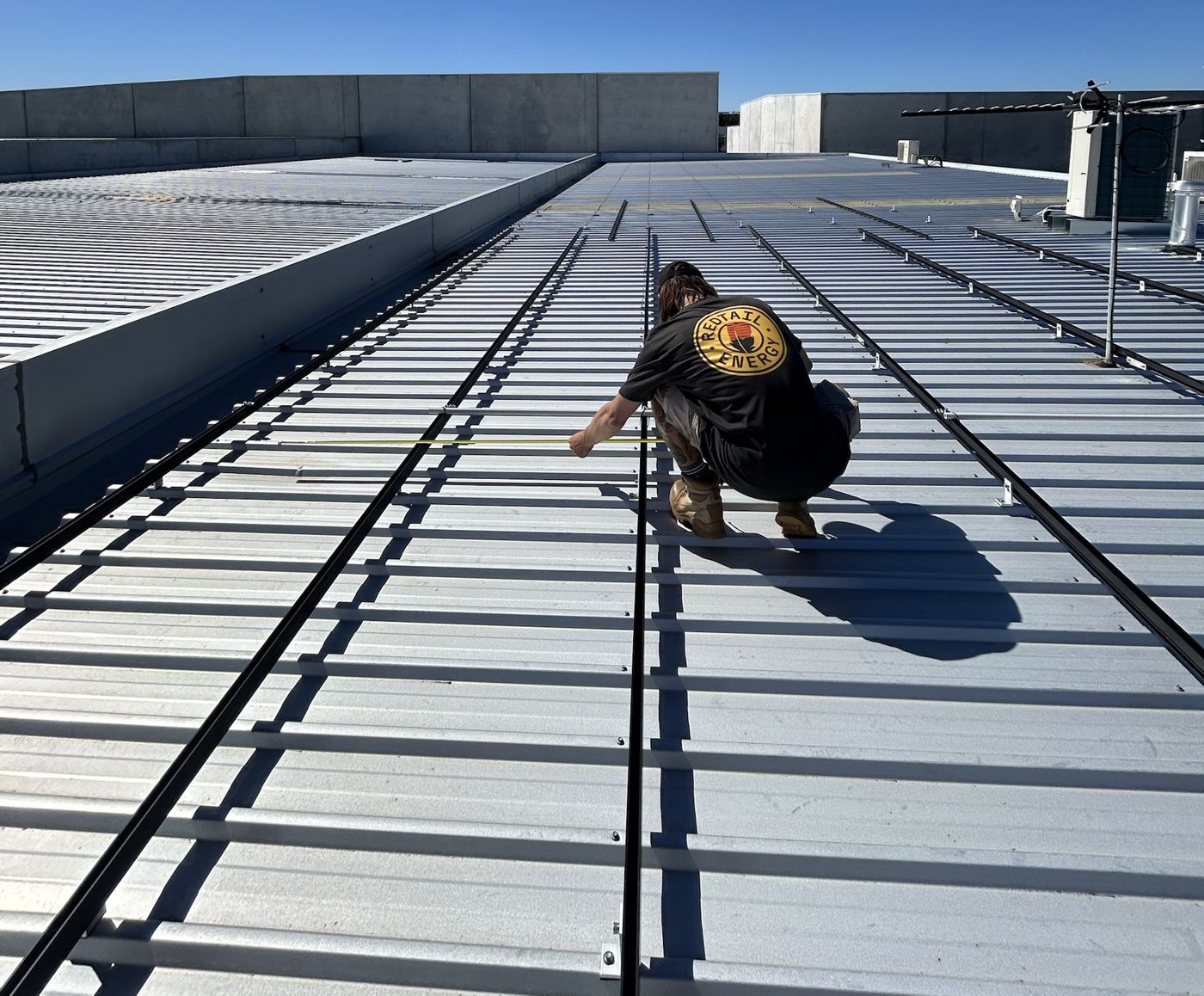 Setting out solar rails on a commercial roof