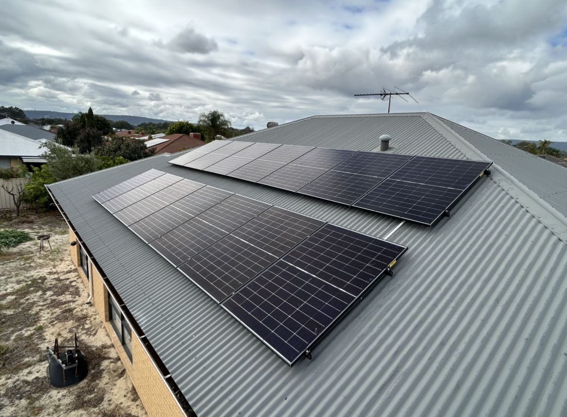 Two rows of solar panels on a metal roof