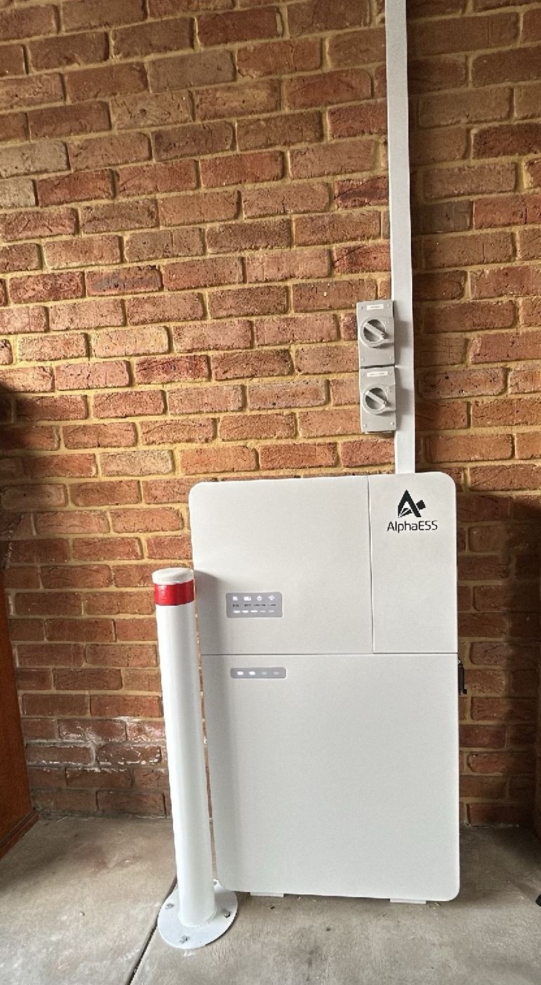 Alpha ESS battery and isolators on a brick wall