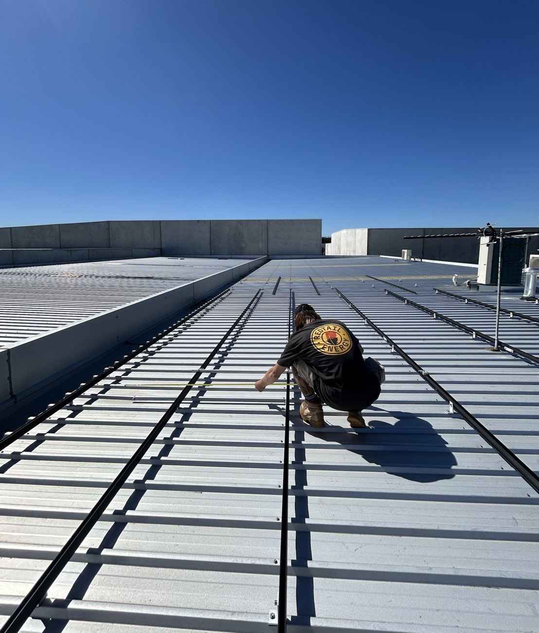 Redtail Energy installer setting out rails on a Perth roof